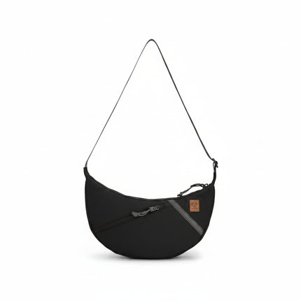 Black crescent-shaped shoulder bag with a single strap and a small brown tag