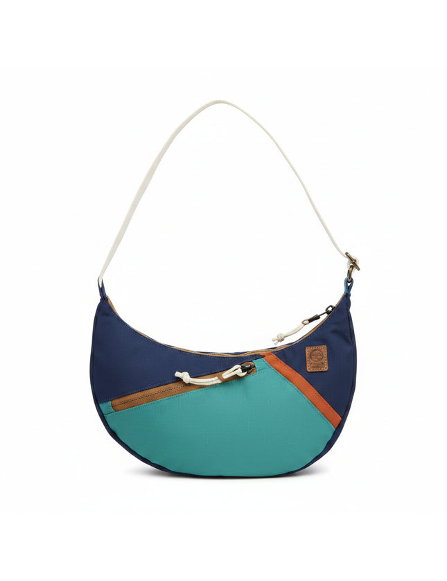 Blue and green crescent shaped shoulder bag with a white strap