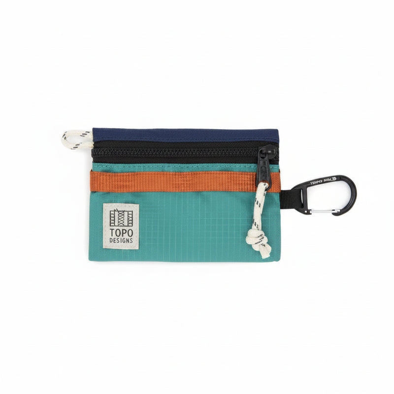Topo Designs accessory bag in teal, orange, and navy with a black zipper and carabiner clip