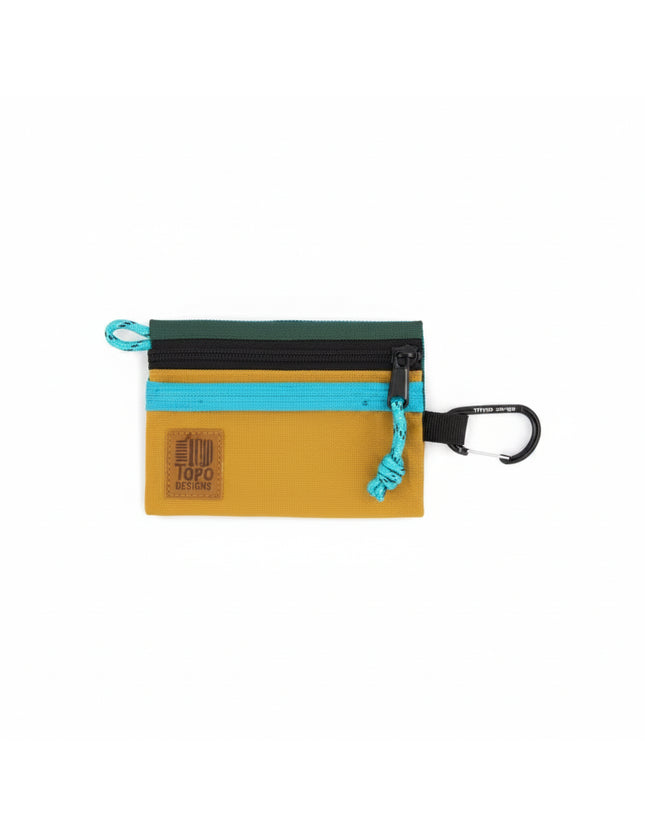 Topo Designs accessory bag in mustard yellow, teal, and dark green with a black carabiner clip