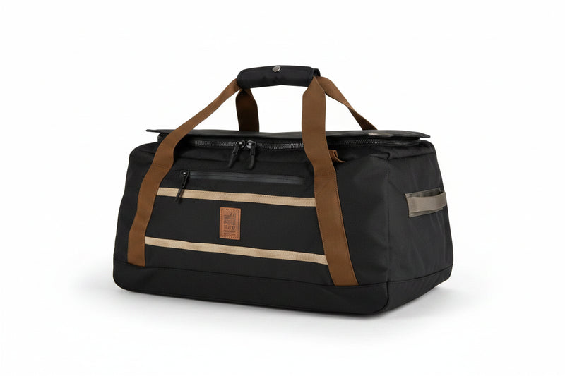 Black duffel bag with brown straps and tan accents