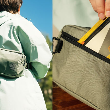 Person wearing a green sling bag over a light green jacket, and a close-up of a hand putting a card into the bag