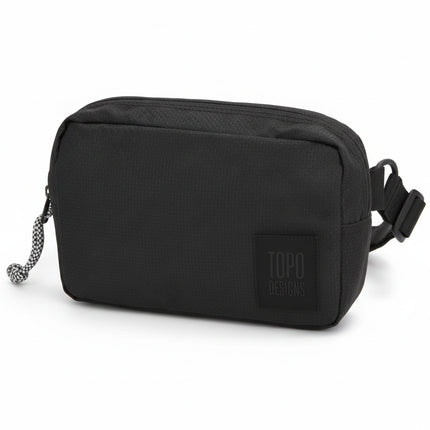 Topo Designs black accessory bag with a black and white zipper pull