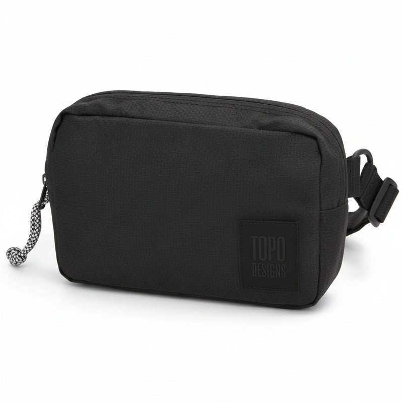 Topo Designs black accessory bag with a black and white zipper pull