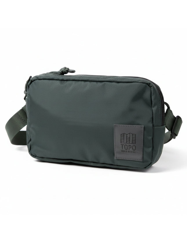 Dark green Topo Designs Rover Pack on a white background
