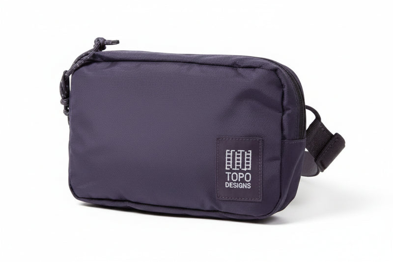 Topo Designs purple accessory bag with white logo