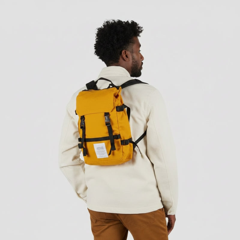 Man facing away wearing a yellow backpack