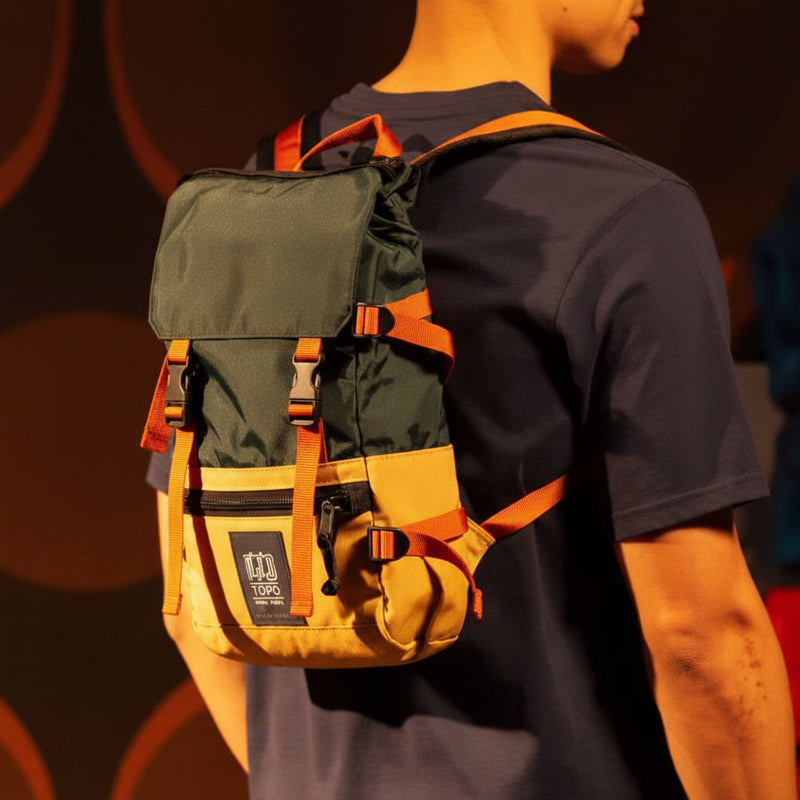 Person wearing a green and yellow backpack with orange straps