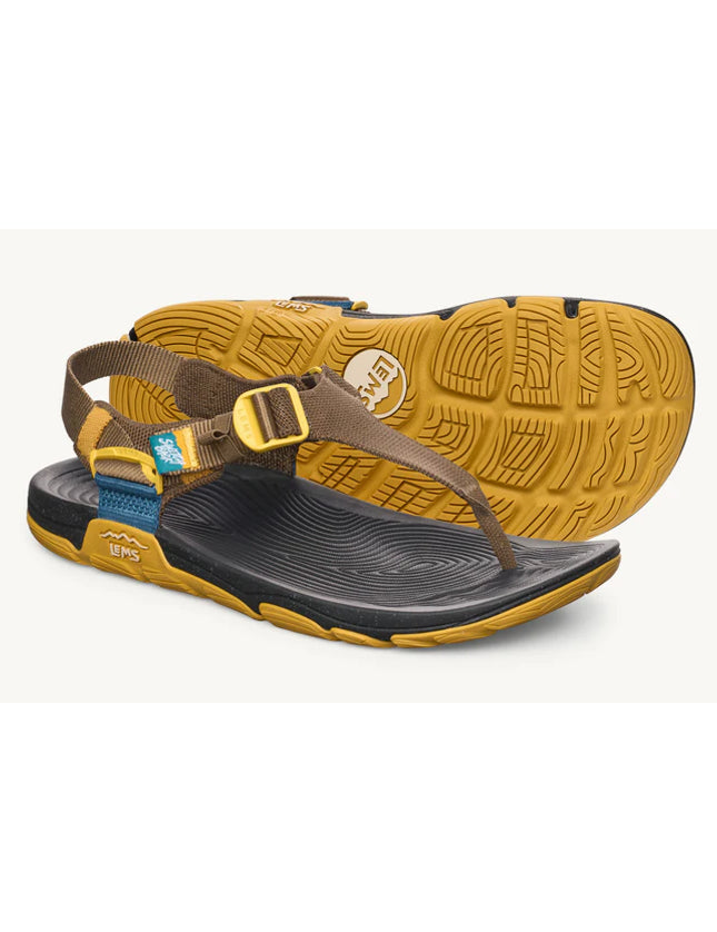 Brown and yellow sandal with a visible brand logo on a white background