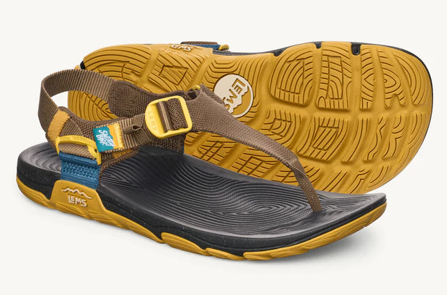 Brown and yellow sandal with a visible brand logo on a white background