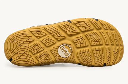 Close-up of a yellow sandal sole with a brand logo on a white background