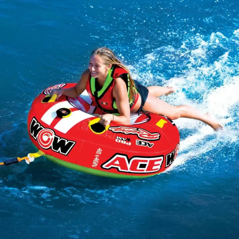 Woman in a life vest on a red and white inflatable tube in the water