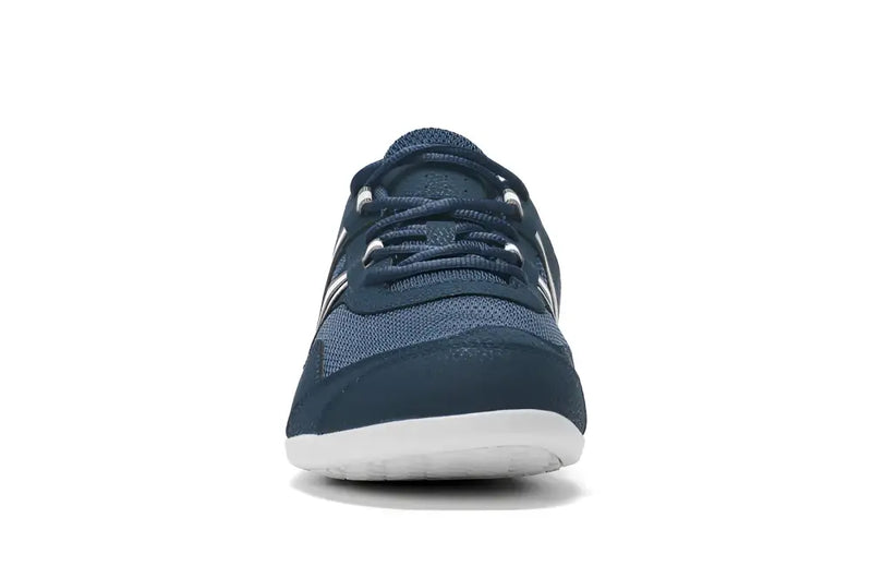 Front view of a navy blue athletic shoe with white soles and laces