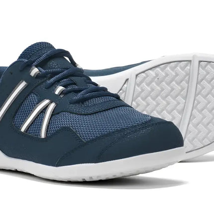 Pair of navy blue sneakers with white soles and white stripes on the sides