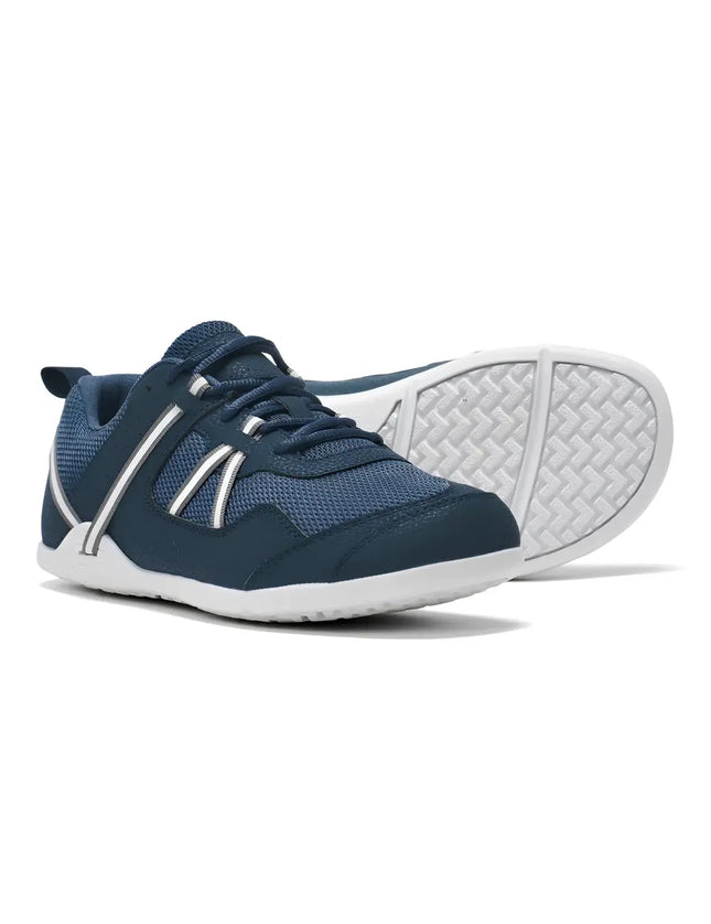 Pair of navy blue sneakers with white soles and white stripes on the sides