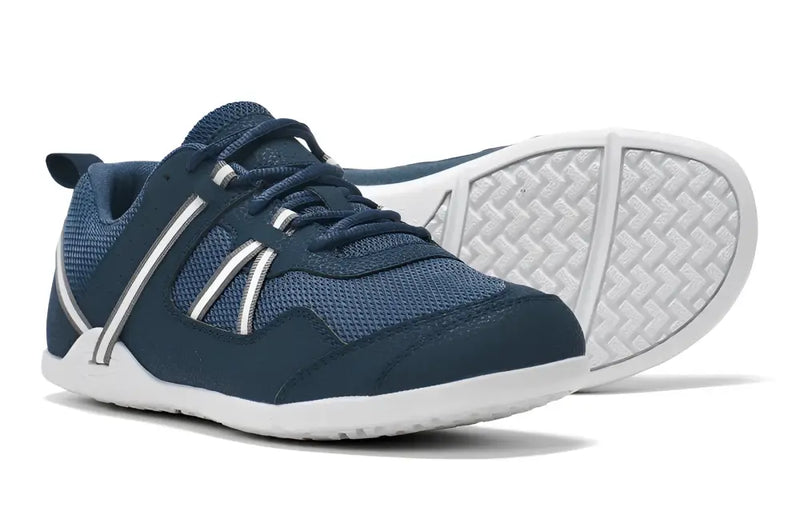 Pair of navy blue sneakers with white soles and white stripes on the sides