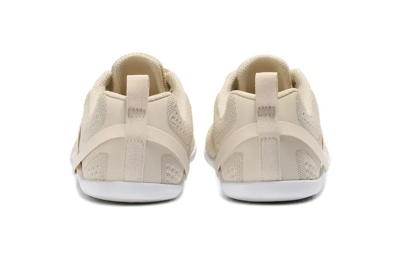 Rear view of two beige athletic shoes with white soles
