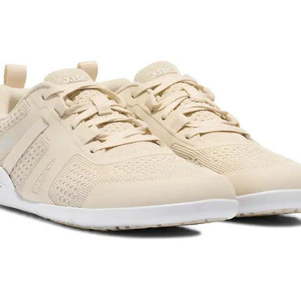 Pair of light beige athletic shoes with white soles