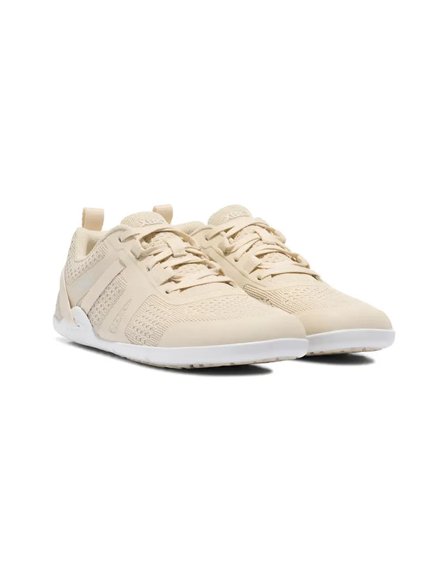 Pair of light beige athletic shoes with white soles