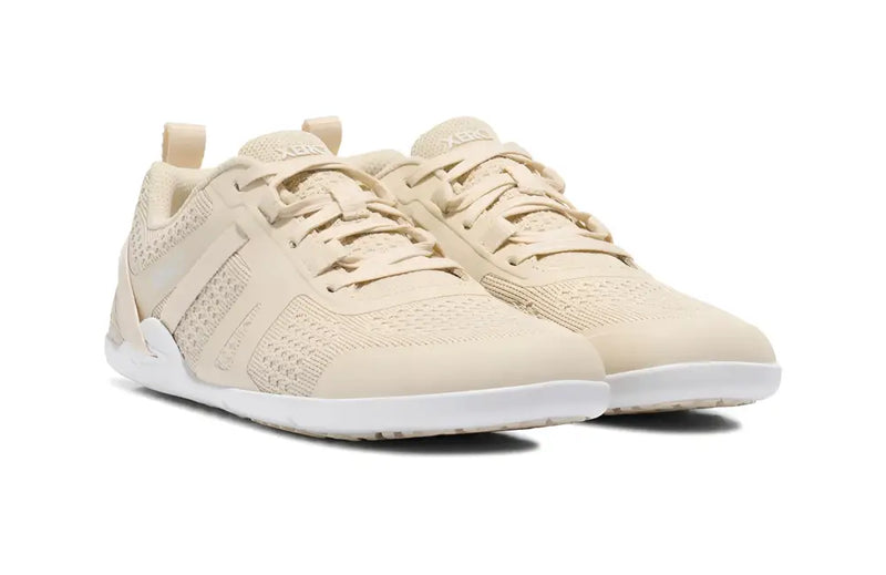 Pair of light beige athletic shoes with white soles