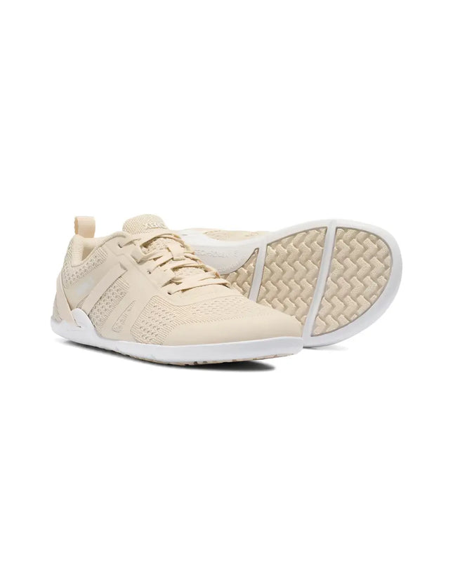 Pair of light beige athletic shoes with white soles, one shoe upright and the other on its side showing the sole